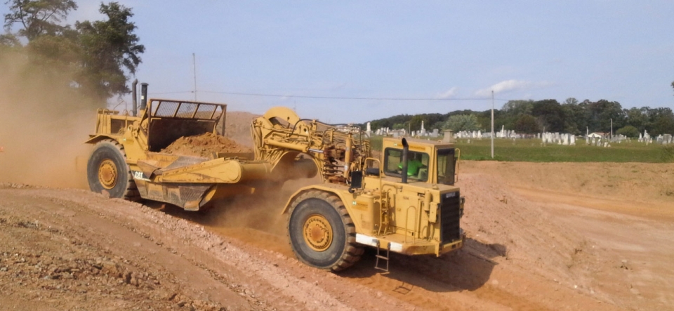 Pan excavator clearing land for residential development