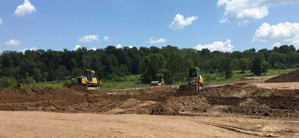 construction equipment doing excavating on construction jobsite