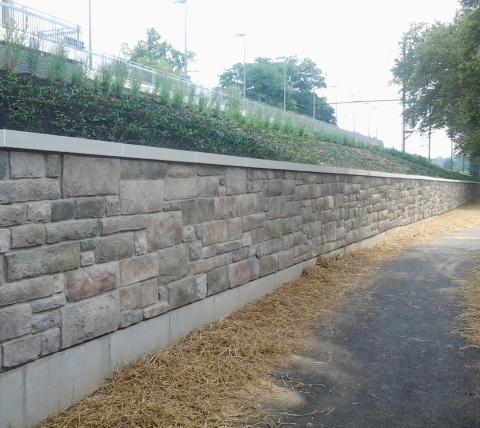 stone retaining wall with path and plantings