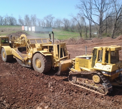 scraper and dozer on construction site