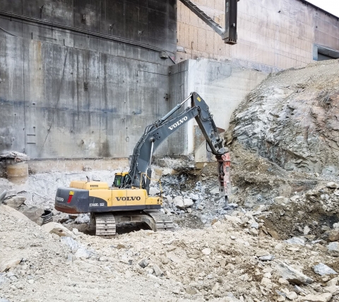 breaker breaking rock at excavating site