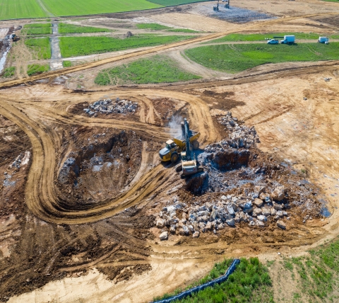 excavating equipment removing rock on large construction site