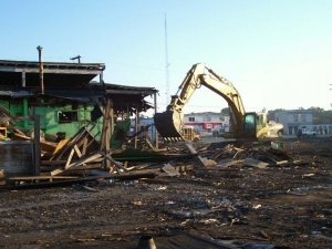 backhoe knocking down building