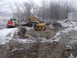 Excavator works in snow