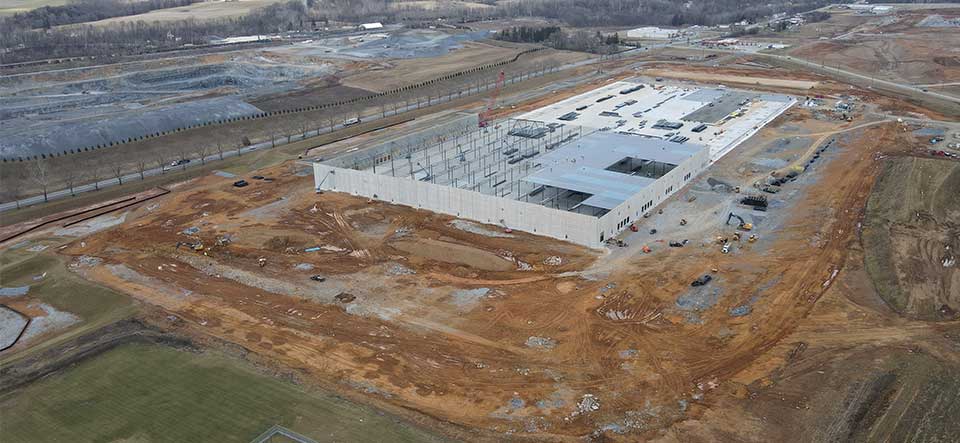 aerial view of large warehouse building under construction