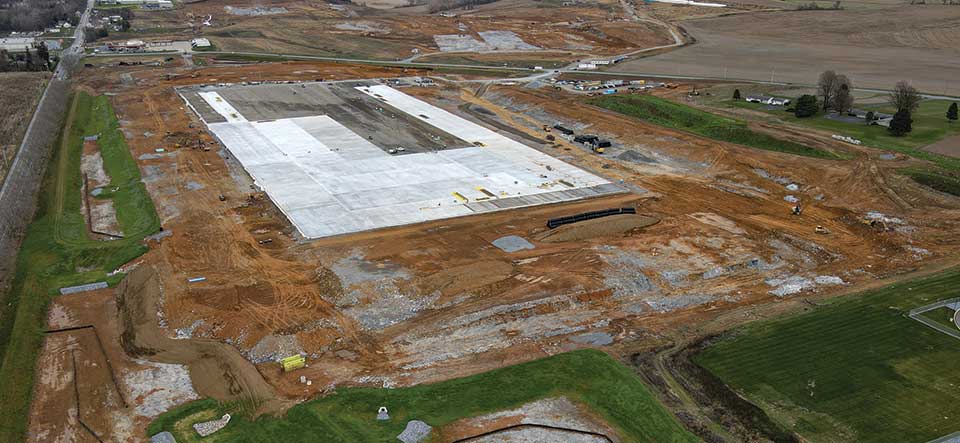 aerial view of large warehouse building pad under construction