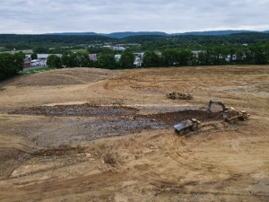 aerial shot of excavating machinery working on construction site