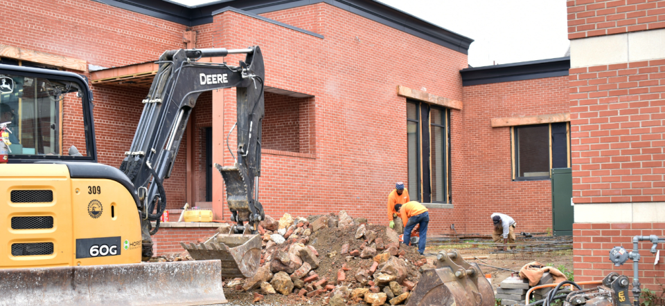 small excavating project team working on commerical building courtyard