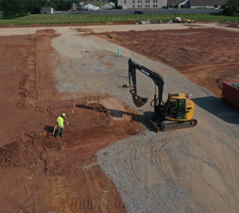 excavator and construction worker